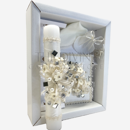 The image features a beautifully designed 5-piece baptism candle set, including a candle, a towel, rosary, bible and a shell. The candle is adorned with white fabric, a braided nylon rope, small white flowers, and rhinestone embellishments, pearl beads, and mirror pieces  giving it an elegant and sacred look. 