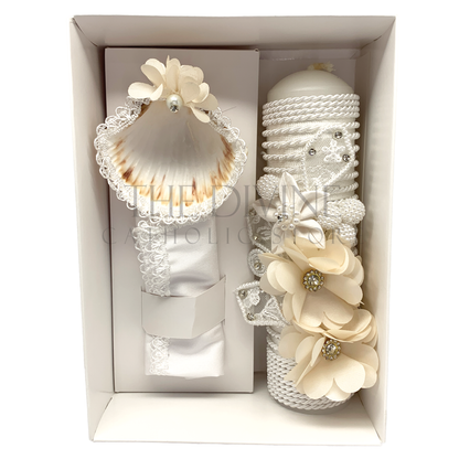 A sophisticated 3-piece baptism candle set consisting of a candle, towel, and shell. The candle is exquisitely wrapped in white fabric, accented with braided rope, delicate floral details, and shimmering rhinestones, symbolizing purity and grace. The towel and shell complete the ceremonial set, ideal for a memorable baptism event.