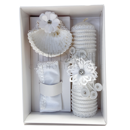 A sophisticated 3-piece baptism candle set consisting of a candle, towel, and shell. The candle is exquisitely wrapped in white fabric, accented with braided rope, delicate floral details, and shimmering rhinestones, symbolizing purity and grace. The towel and shell complete the ceremonial set, ideal for a memorable baptism event.