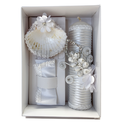 A sophisticated 3-piece baptism candle set consisting of a candle, towel, and shell. The candle is exquisitely wrapped in white fabric, accented with braided rope, delicate floral details, and shimmering rhinestones, symbolizing purity and grace. The towel and shell complete the ceremonial set, ideal for a memorable baptism event.