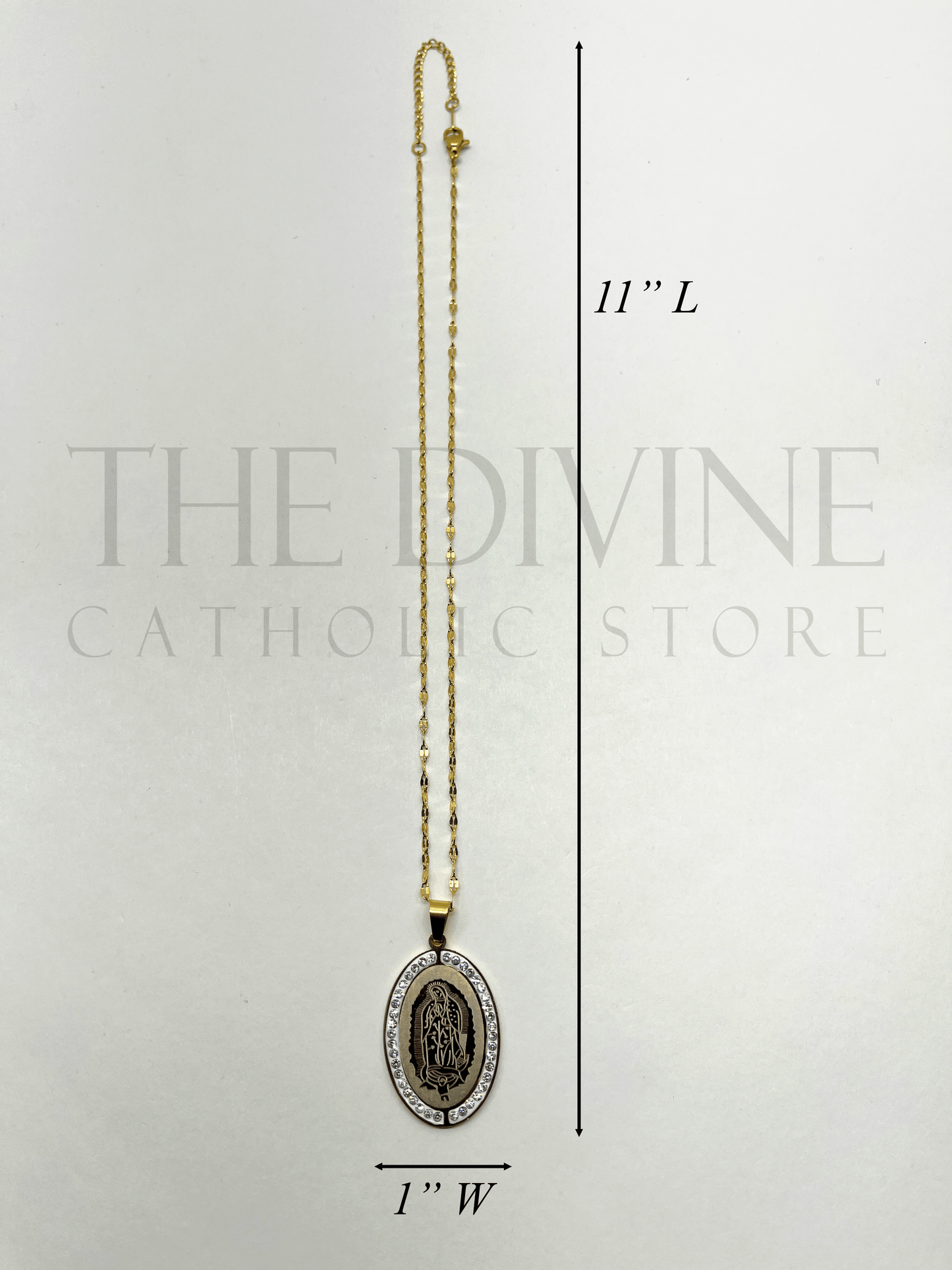 Our Lady of Guadalupe Necklace Set with stainless steel pendant (11" length, 1" width) and matching earrings, featuring intricate detailing of the Virgin of Guadalupe.