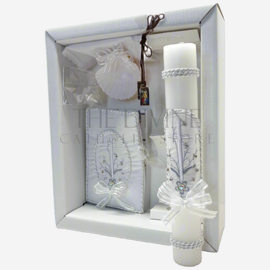 The image features a beautifully designed 6-piece baptism candle set, including a candle, a towel, rosary, bible, scapular, and a shell. The candle is adorned with white fabric, a braided nylon rope design, small white flowers, ribbon and rhinestone embellishments, giving it an elegant and sacred look. 