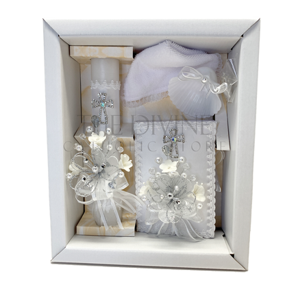 The image features a beautifully designed 5-piece baptism candle set, including a candle, a towel, rosary, bible, and a shell. The candle is adorned with white fabric, a braided nylon rope, small white flowers, and rhinestone embellishments, giving it an elegant and sacred look. 