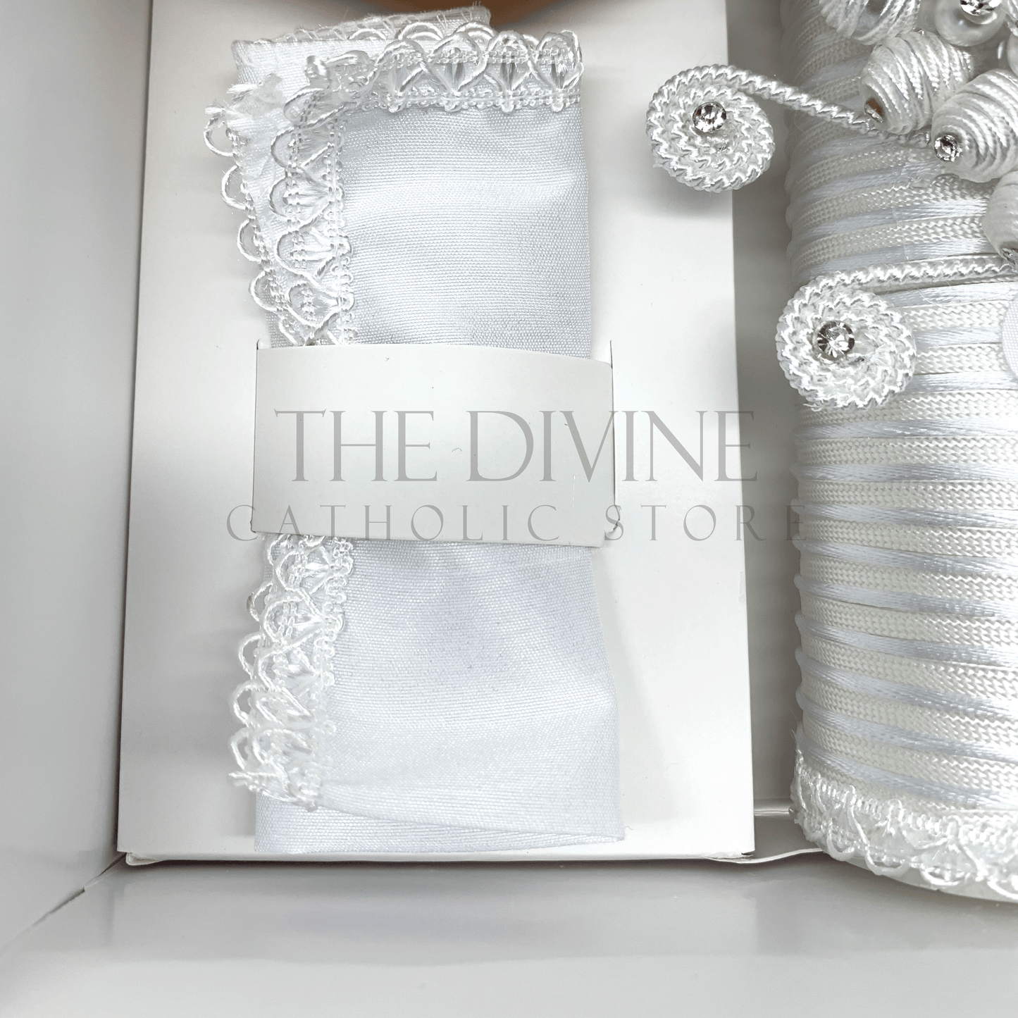 Close up of the 3 piece baptism candle set white fabric towel, embroidered in white nylon thread.