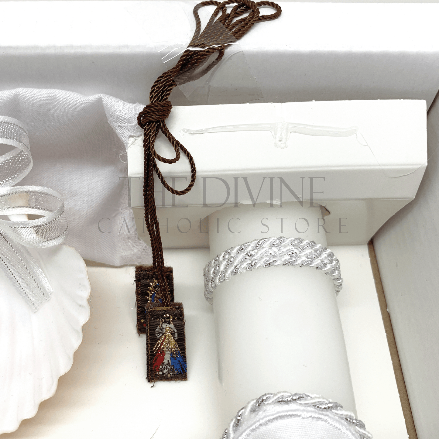 Close up image of the 6 piece baptism candle set scapular showing image of the Divine Mercy image and Our Lady of Guadalupe. 