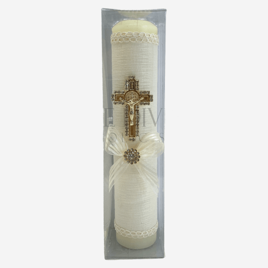 Single ivory baptism candle, decorated with ivory fabric, embroidered with ivory thread, gold colored St. Benedict crucifix outlined in rhinestones, and ivory bow with rhinestone in middle. 